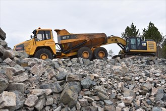 Tracked excavator and dump truck for road construction in Norway
