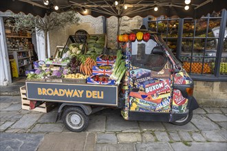A Piaggio Ape tricycle as a vegetable stall on the high street of Broadway