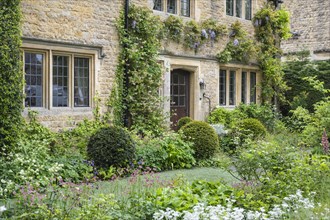 Typical stone house in the Cotswolds with lush gardens