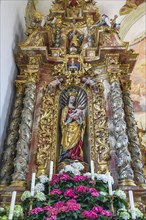 Side altar with figure of the Virgin Mary and floral decoration