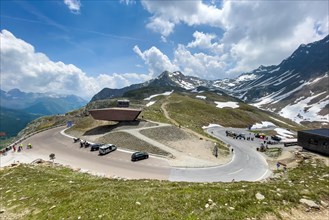 View on pass road alpine pass mountain road pass height of 2509 metres high Timmelsjoch Passo Rombo with pass museum from right Austrian territory to left in air of Italian territory