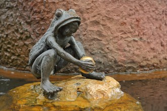 Fairytale fountain with sculpture Frog Prince and golden ball in the water
