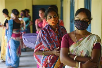 Women waiting to receive COVID-19 coronavirus vaccine dose during a vaccination campaign on the outskirt of Guwahati in India on Monday