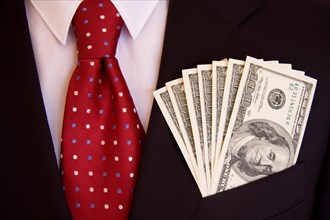 Hundred dollar bills in man's suit pocket