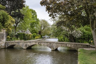 Old footbridge over the River Windrush in the Old Town of