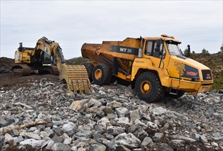 Tracked excavator and dump truck for road construction in Norway