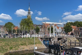 Cityscape at the marina with Queen Beatrix Bridge and historic town hall