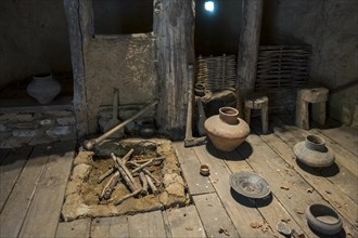 Interior of reconstructed Bronze Age house showing pottery and tools at the open-air Archeosite and Museum of Aubechies-Beloeil