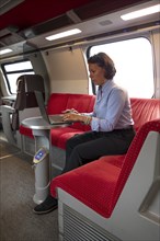 Business woman sitting in first class train
