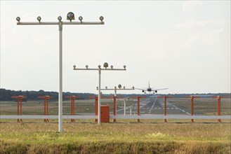 Passenger aircraft approaching a runway at Hamburg Airport