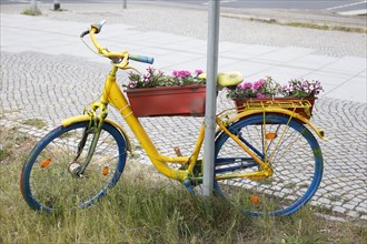 Colourful bicycle decorated with flowers and flower boxes