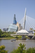 View from the Tache Promenade of the Red River with Provencher Bridge and the Winnipeg skyline behind it