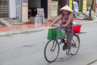 Vietnamese woman riding on bicycle
