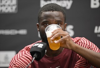 Frances Tiafoe USA drinks German beer during press conference
