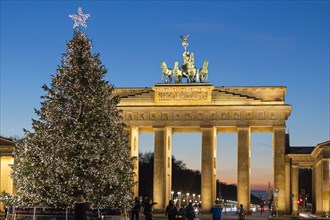 Christmas in Berlin. An illuminated Christmas tree in front of the Brandenburg Gate. Berlin
