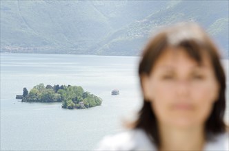 Close up on a Woman and Brissago Islands in the Background with a Passenger Ship in Ticino