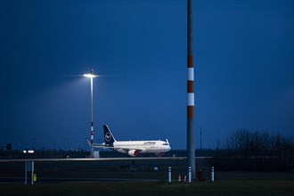 A parked Lufthansa aircraft photographed at Berlin-Brandenburg BER Airport in Schoenefeld