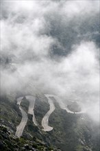 The winding road from Sa Calobra to Coll dels Reis in the Tramuntana Mountains with clouds