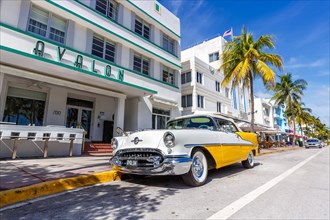 Avalon Hotel in Art Deco style architecture and vintage car on Ocean Drive in Miami Beach