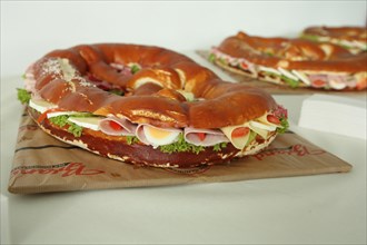 Large pretzel with cheese and sausage