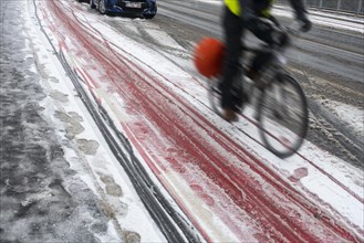 Motion blurred cyclist cycling on slippery bike path