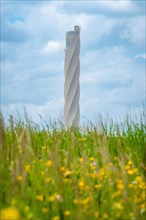 Thyssen Krupp test tower behind flower meadow in spring