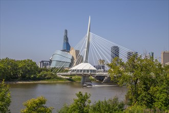 View from the Tache Promenade of the Red River with Provencher Bridge and the Winnipeg skyline behind it