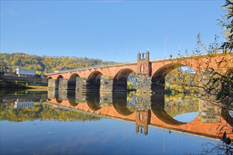 UNESCO Roman Bridge over the Moselle with autumn colouring and reflection
