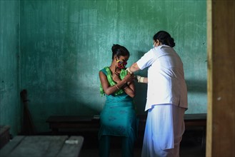 Health worker administers a COVID-19 coronavirus vaccine during a vaccination drive on the outskirt of Guwahati in India on Monday