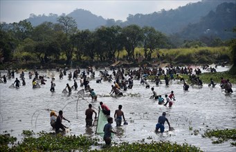 Villagers participate in a community fishing event on the occasion of Bhogali Bihu Festival at Goroimari Lake in Panbari village