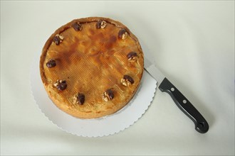 Round whole nut cake with knife