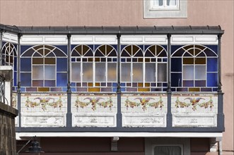 Bay window with stained glass windows and painted tiles