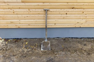 A shovel leans against a wall at a construction site. Berlin