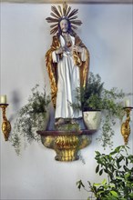 Christ figure with radiating wreath