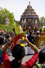 Woman in sari with offerings to the goddess on the main festival day at the big procession Theer