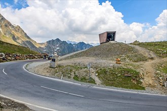View on pass road alpine pass mountain road pass height of 2509 metres high Timmelsjoch Passo Rombo and pass museum on Austrian territory and Italian territory