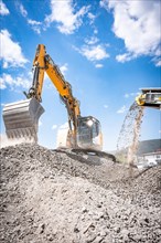 Demolition site with recycling plant and excavator