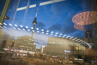 The TV tower at Alexanderplatz is reflected in a disc at blue hour. Berlin