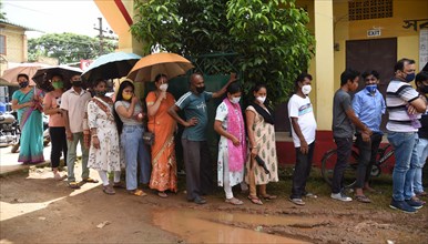 Beneficiaries wait in a queue to receive COVID-19 coronavirus vaccine dose during a vaccination campaign in Guwahati