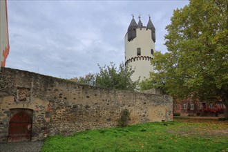 Castle with tower keep and city wall in autumn