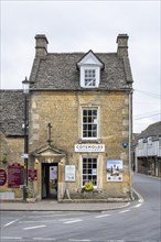 Old stone house with shop of the Cotswolds Distillery in the old town of Bourton on the Water