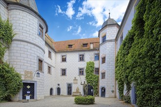 Inner courtyard of Mitwitz moated castle with Neptune fountain and sandstone statue of The Franconian Knight