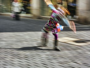 Colourful clown doing a cartwheel