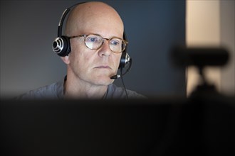 Home office. portrait of a man wearing headphones with a microphone