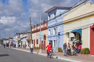 Cubans queuing in front of pastel coloured shop in the main street of the town Guaimaro in the southern part of Camagueey Province