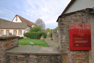 Entrance with information board and text to the Brothers Grimm House