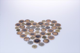 Turkish Lira coins together shape a heart on white background