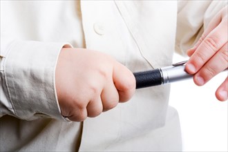 Baby holding a pen in his hand on a white background