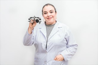 Portrait of female optometrist holding a messbrille lens isolated. Smiling ophthalmologist holding a messbrille isolated