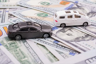 Model cars placed US dollar banknotes spread on ground